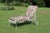 Soak up the sun's warmth as you relax on this retro wrought iron chaise lounge with its two cushions covered in pink and...