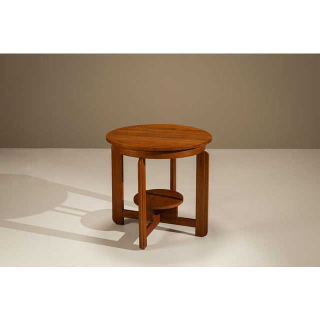 A compact composition with a strong architectural rhythm, this Amsterdam School side table balances solid oak with a...