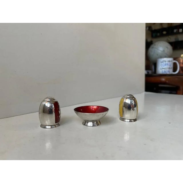 Beautiful set consisting of salt and pepper shaker i sterling silver and maroon/red and lemon yellow enamel guilloche....