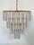 1970s chandelier, brass structure and trilobe pendants in transparent and white Murano glass, the height of the chandelier...