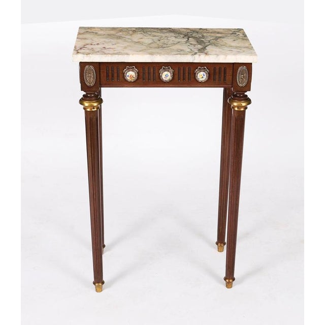 This is an elegant petite French Louis Revival console table dating from the 1950's. This magnificent piece is crafted...