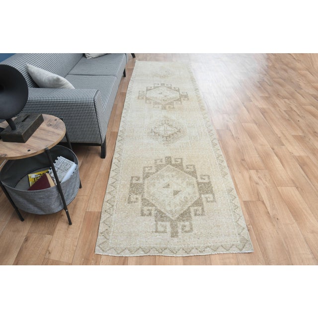 Vintage Hand-Knotted runner rug is a semi-antique vintage area rug. The '70s Eastern region of Anatolia's unique rug is...