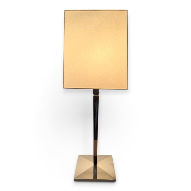 A pair of silver table lamps with tapered columns and modern square shades. Casting a beautiful glow on the silver finish,...