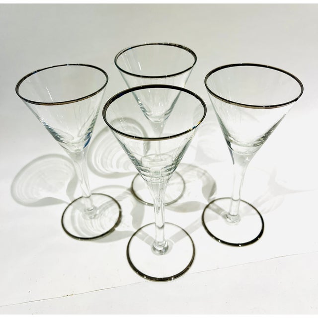 Sweet, vintage set of four cocktail glasses. Perfect for gimlets! Silver rim around the top of the glass, and a silver rim...