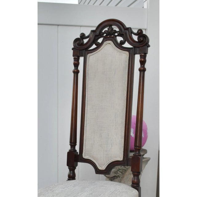 Vintage (1980's) Accent Chair has a Jacobean Style. High Back, Carved Walnut, with a Stretcher Base. Patterned Fabric Off...
