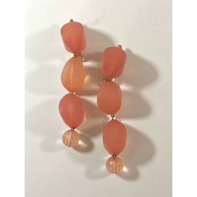 This is a fabulous pair of 1970s Peach Lucite Long Dangle Drop Earrings ready for a night out on the town! Whether you...