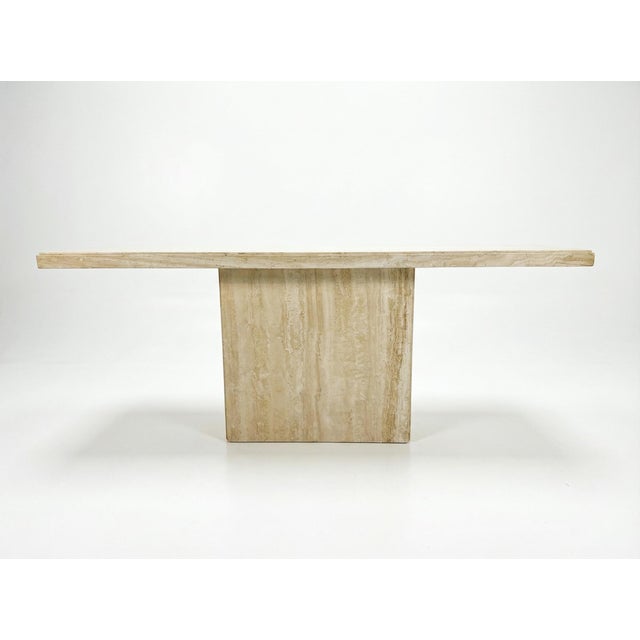 A classic 1970s Italian modern console table constructed of solid filled travertine. This piece features a two-part...