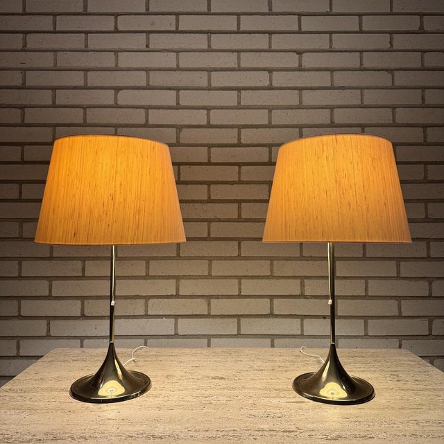One of the lamps has some scratches, se photo. Height to socket 49cm Height with lamp shade 67cm This piece has an...