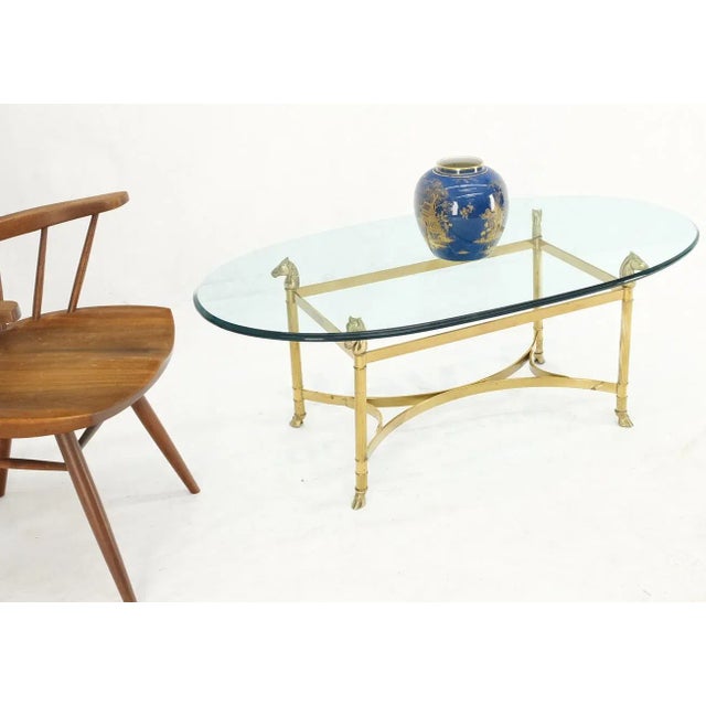 Horse head hoof feet brass base oval glass top coffee center table.
