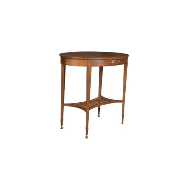 Early 20th Century George Hepplewhite style oval carved mahogany two tiered accent or occasional table with caned shelf,...