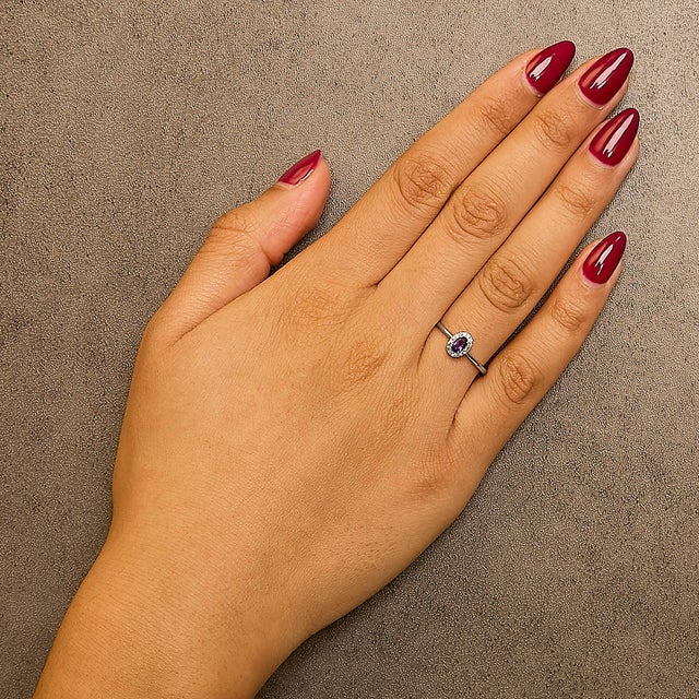 Elegant and radiant, this exquisite ring is a symphony of color and light, masterfully crafted from rhodium-plated 10K...