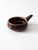 Vintage handmade studio pottery bowl with a rounded form, short tapered handle, and horizontal bands circling the...