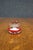 Heavy art glass paperweight featuring a ruby red overlay with hand-cut laurel wreath and cross surrounding a frosted...
