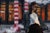 Dividing Lines depicts a figure standing amidst a stark urban landscape, characterized by bold strokes and a contrasting...