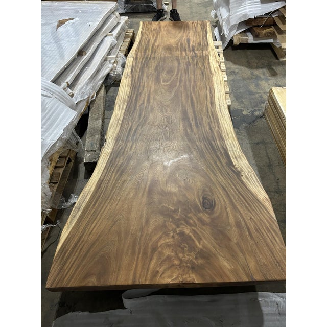 One tree. One top. One of one. A true single-slab live edge table: one continuous cross-section of a single Saman tree...