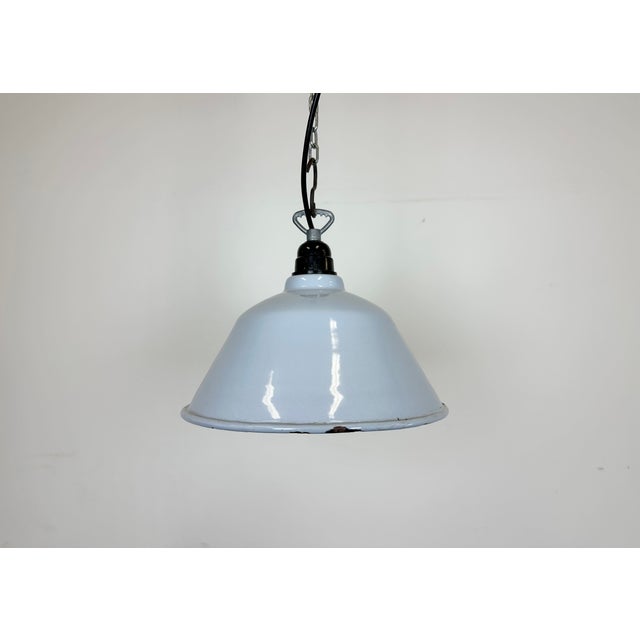 Industrial light grey enamel factory pendant light made in France during the 1960s. White enamel inside the shade. The...