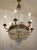 Empire-style chandelier in the shape of a hot air balloon, crafted from brass and decorated with glass and crystal drops....