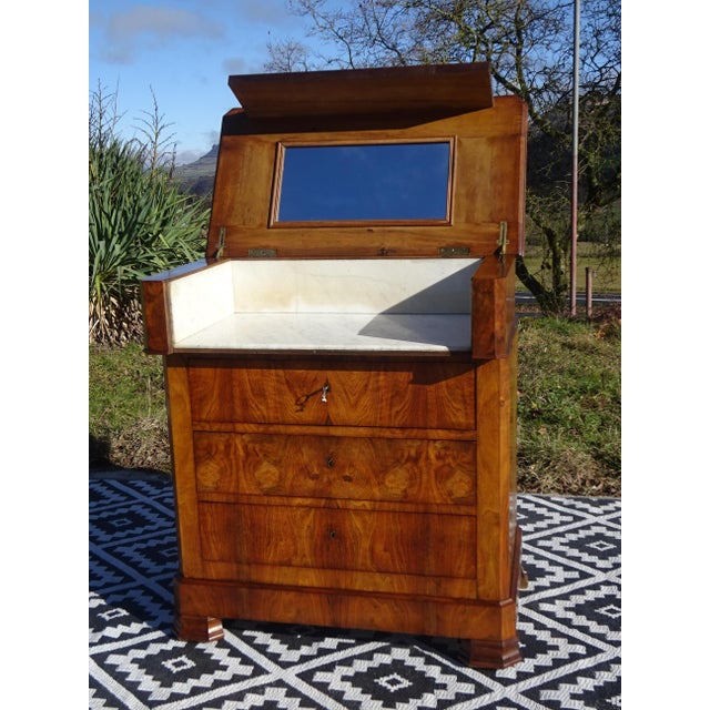 A Louis Philippe style dressing table or vanity unit. Made entirely of solid wood, with walnut burl veneer on the fronts,...