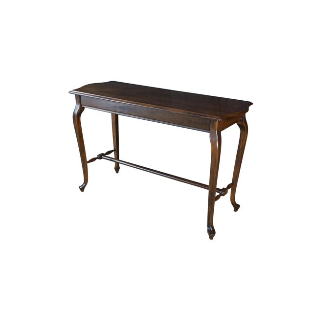 Vintage Queen Anne style console table, showcasing classic design elements from the mid-to-late 20th century. Crafted from...