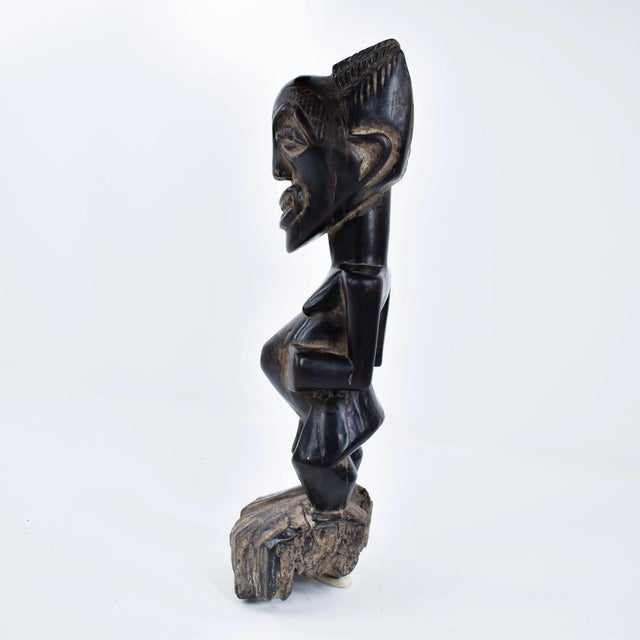 This figure has a strongly defined body and the well-known Songye jutting chin and geometric nose with the eyes...