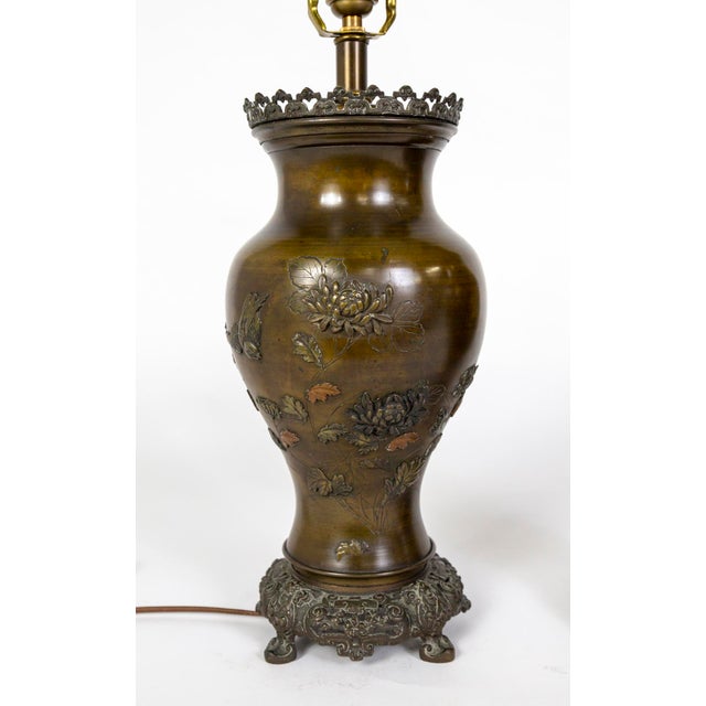 A pair of large, cast bronze, urn-shaped lamps made circa 1885-1890, during the Meiji period (1868-1912) in Japan. They...