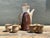 This exquisite six-piece studio pottery set showcases a masterful blend of Mid-Century Modern aesthetics and organic...