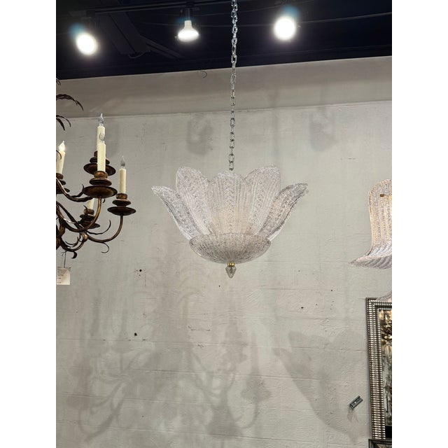 The Murano Clear Granola Glass Leaf Chandelier is a stunning decorative piece that adds elegance and style to any room....