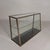 Chic counter display case with 4 glass shelves with different depths. The display case slopes upwards. The sliding doors...