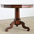 A spellbinding Italian tilt-top table whose geometric surface is a meticulous arrangement of inlaid mahogany, ebonized...