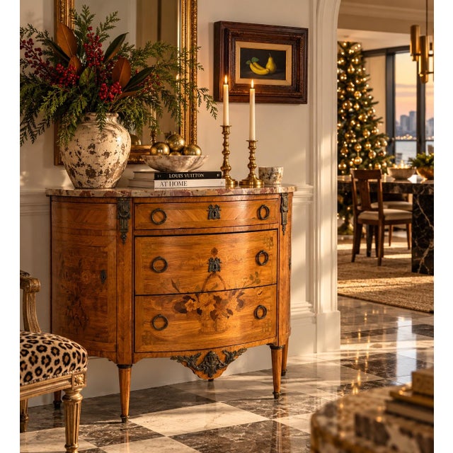 Exquisite 19th-century French Louis XVI-style demi-lune cabinet featuring intricate floral marquetry inlay, a beautifully...