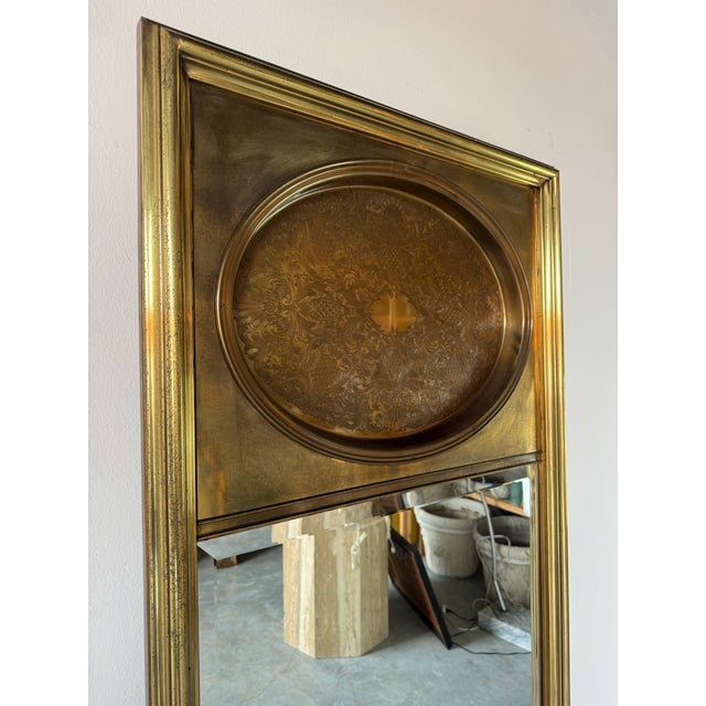 A striking 1970s vintage wall mirror by Mastercraft, embodying the opulence of Hollywood Regency design. This tall,...