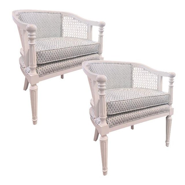 A beautiful pair of vintage barrel lounge chairs. Featuring gracefully curved frames with handwoven cane side and back...