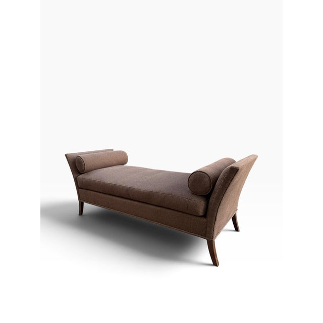 An elegant upholstered chaise daybed by Bright Chair Company, featuring a sophisticated silhouette with dramatically...