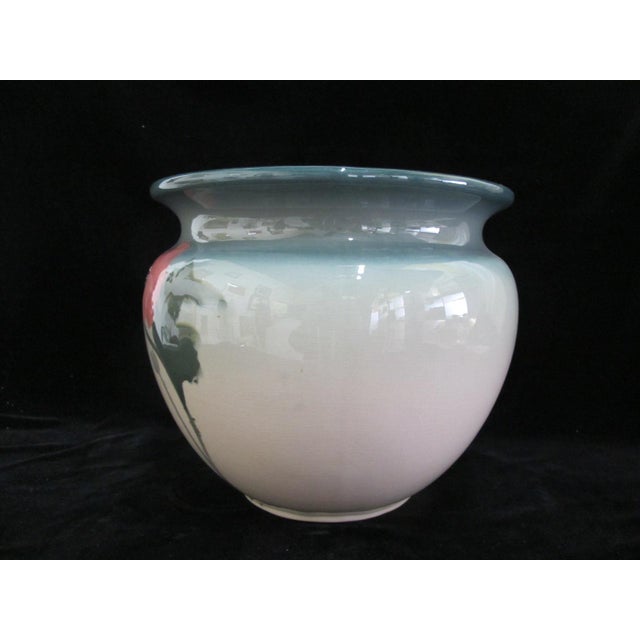 Delightful vintage Weller art pottery vase. Glazed in tones of green with a large pink flower. Measures 10" tall x 11...