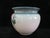 Delightful vintage Weller art pottery vase. Glazed in tones of green with a large pink flower. Measures 10" tall x 11...