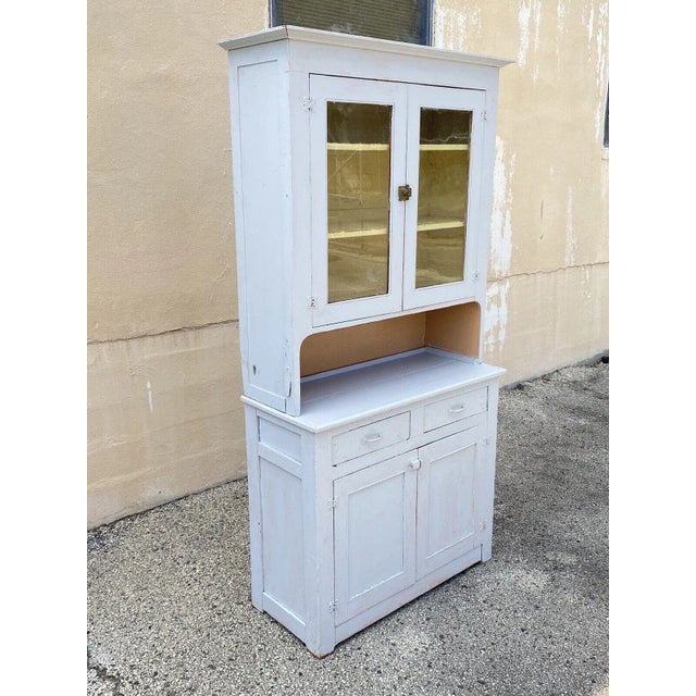 Antique Country Primitive White/Gray Painted 2 Piece Step Back Hutch Kitchen Cupboard. Item features 2 part construction,...