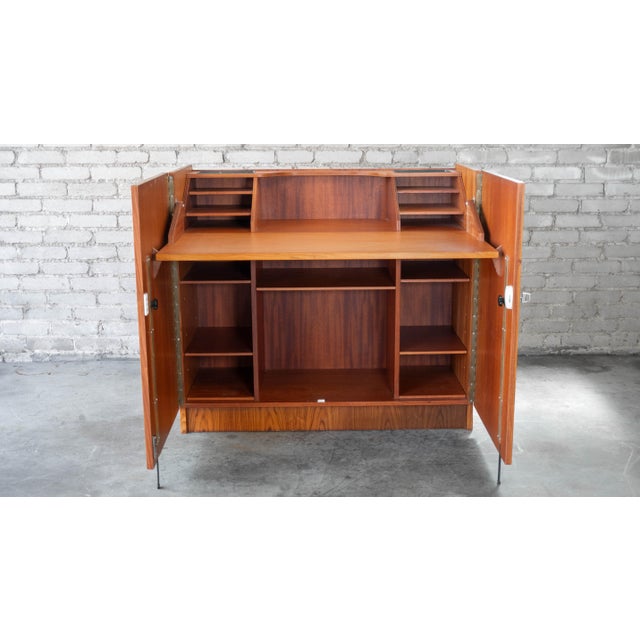 Mid Century Brazilian Rosewood and Teak Hideaway Desk and Cabinet by Gritsch. Versatile piece with ample storage as a...