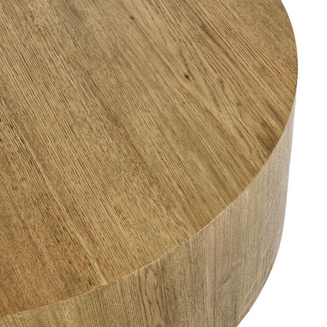 Modern round block coffee table crafted from natural oak wood and oak veneer, showcasing warm organic tones and subtle...