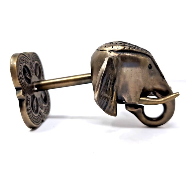 This cast brass elephant head wall mount coat purse hook is a unique piece. Made in India, this hook features intricate...