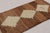 Hand-knotted in wool circa 1950-1960, this 3x6 vintage Persian Gabbeh runner rug is a captivating example of nomadic...