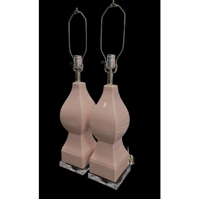 Add a touch of vintage Palm Beach glamour to your space with this chic pair of sculpted ceramic table lamps. Rendered in a...