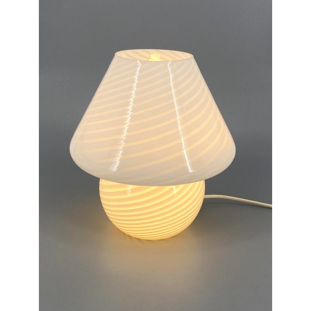 * A table lamp / mushroom lamp * Made entirely of Murano glass * White * with a pattern in the material * Manufacturer:...