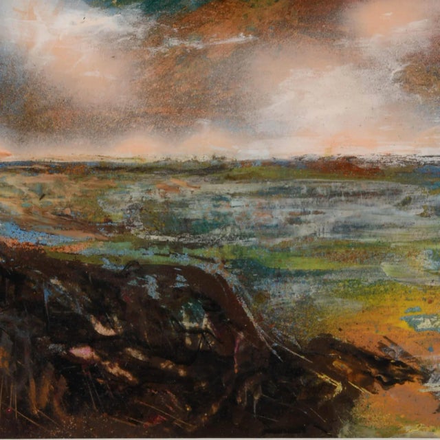 This Framed J. Akston "Mystery in the Skies 1974" Acrylic on Paper captures a turbulent skyscape above a richly colored...