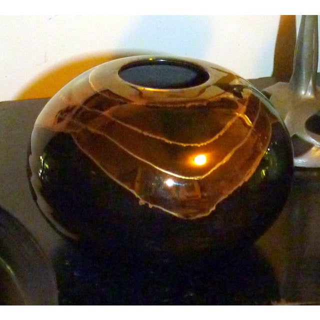 This striking spherical "orb" vase is a hand-thrown porcelain piece by renowned Sacramento studio potter Bruce Fairman. It...