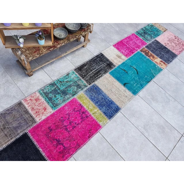 This is a vintage Turkish Oushak rug from the Mid 20th Century. The piece was hand-knotted.