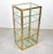Cabinet etagere in glass featuring a brass structure and chrome details in the style of the Italian designer Renato Levi....
