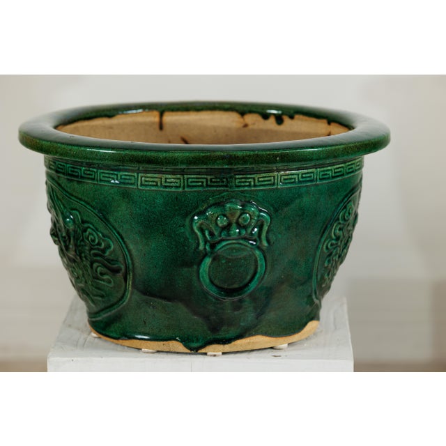 "About the Item This large Chinese planter is finished in a rich green glaze that highlights its bold relief decoration....