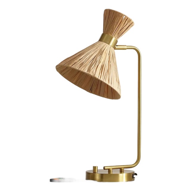 Introducing the SOHMA Table Lamp, where functionality meets simplistic elegance. Finished in a soothing brass tone, this...