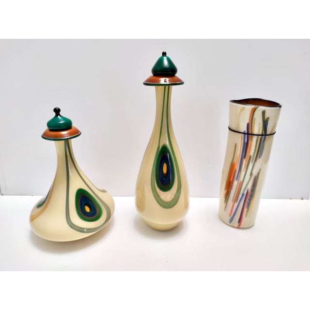 Made in Italy, 1960s - 1970s. This decanter bottle is part of a three-piece set. It is made in three-color encased glass...