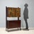 1960s bar cabinet in mahogany veneer, featuring a polyester finish that enhances the wood's natural grain. The top section...